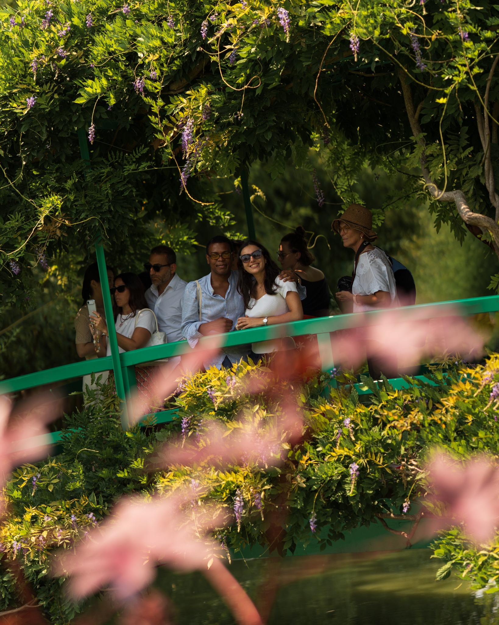 Visitors framed by flowers in Monet's garden