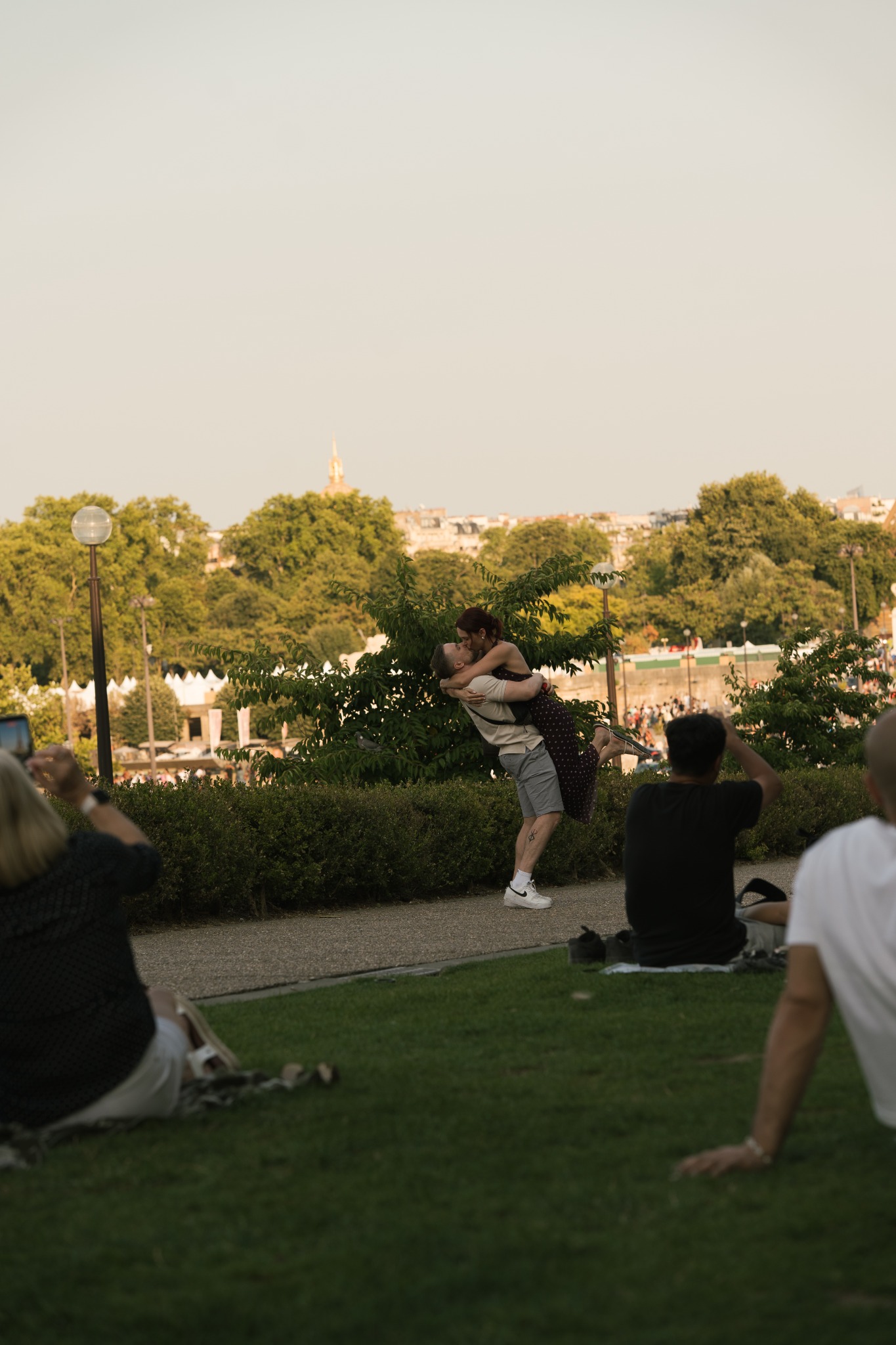 Newly engaged couple embracing in a Paris garden